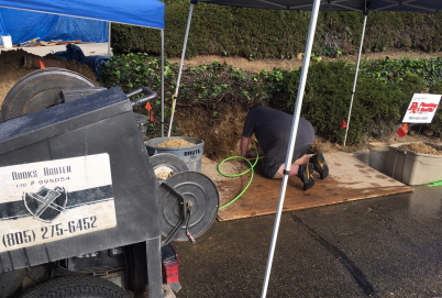 Sewer line repair during rainstorm in Ventura